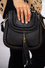 small black bag with tassel strap